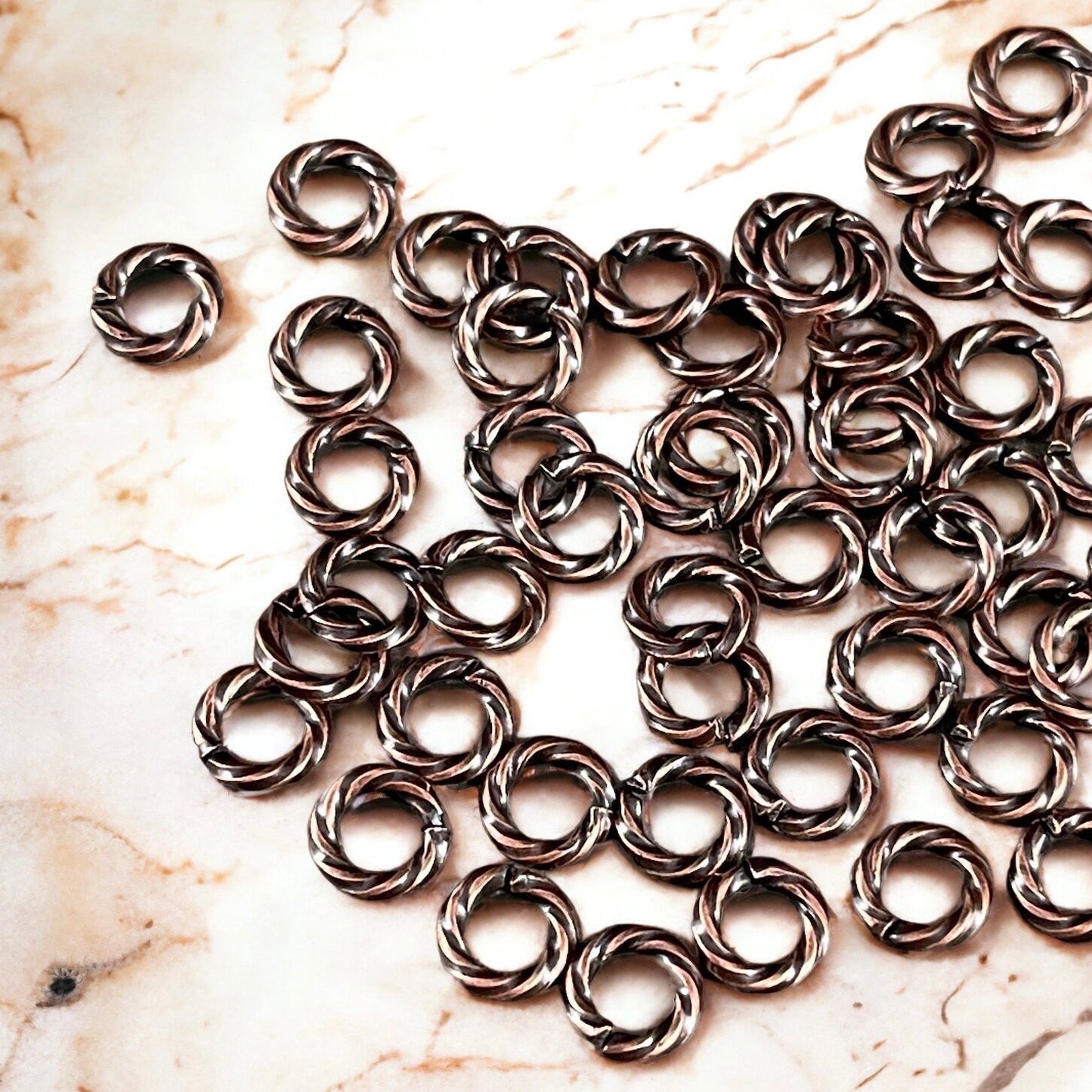 6mm Twisted Jumprings, 16g Open, Antiqued Copper Plated Brass (FMG/5044) * Qty. 100