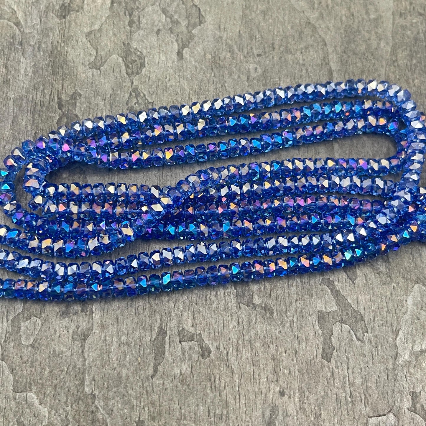 Faceted Glass Beads - 4x2.5mm Heishi Rondelles, Transparent Light Sapphire Blue with AB Finish (LtSapphire-AB) * 7" Strand