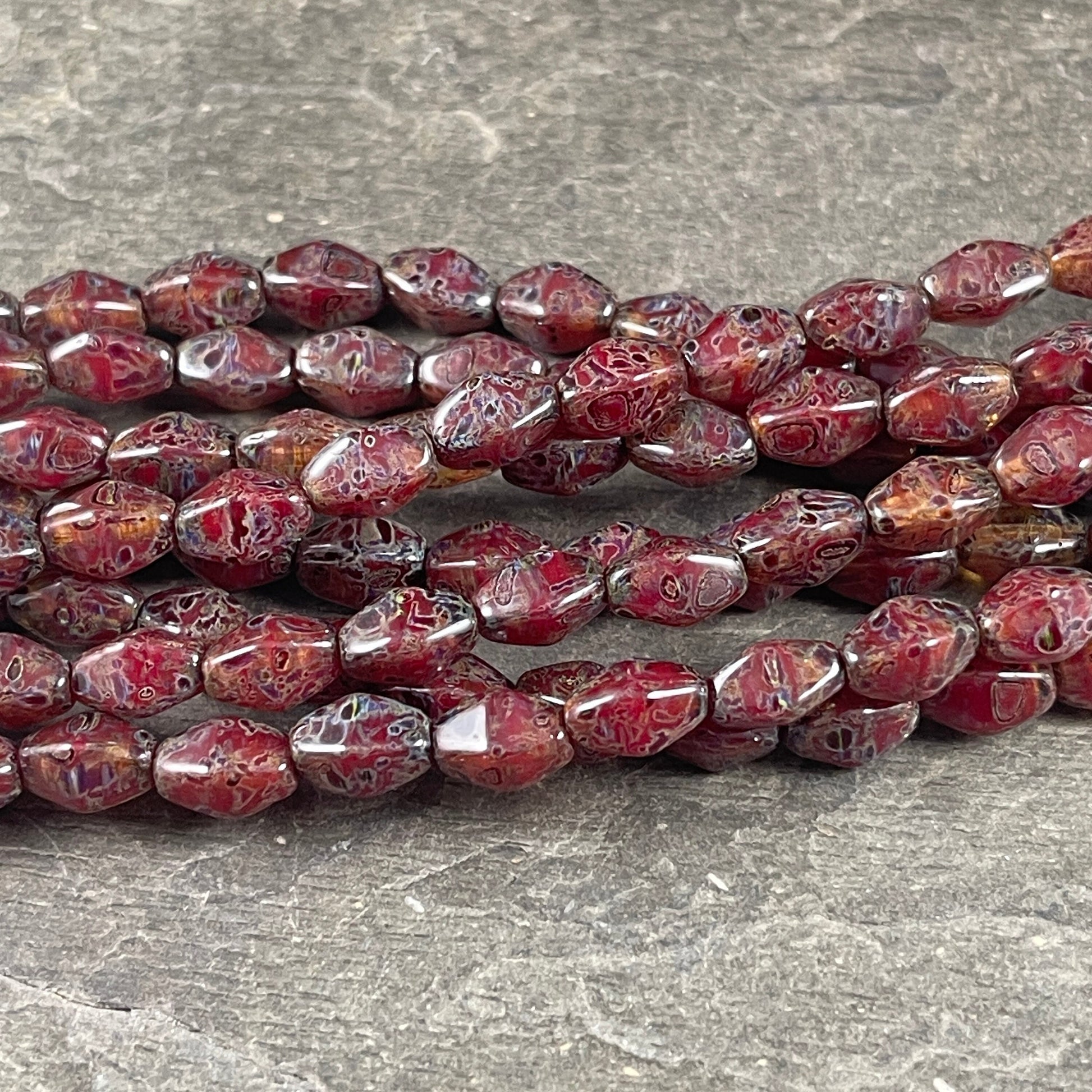 Transparent Crystal Red with Travertine Picasso , 8x6mm Dark Red, Rustic Picasso, Elongated Bicone (EB5) * Qty. 16