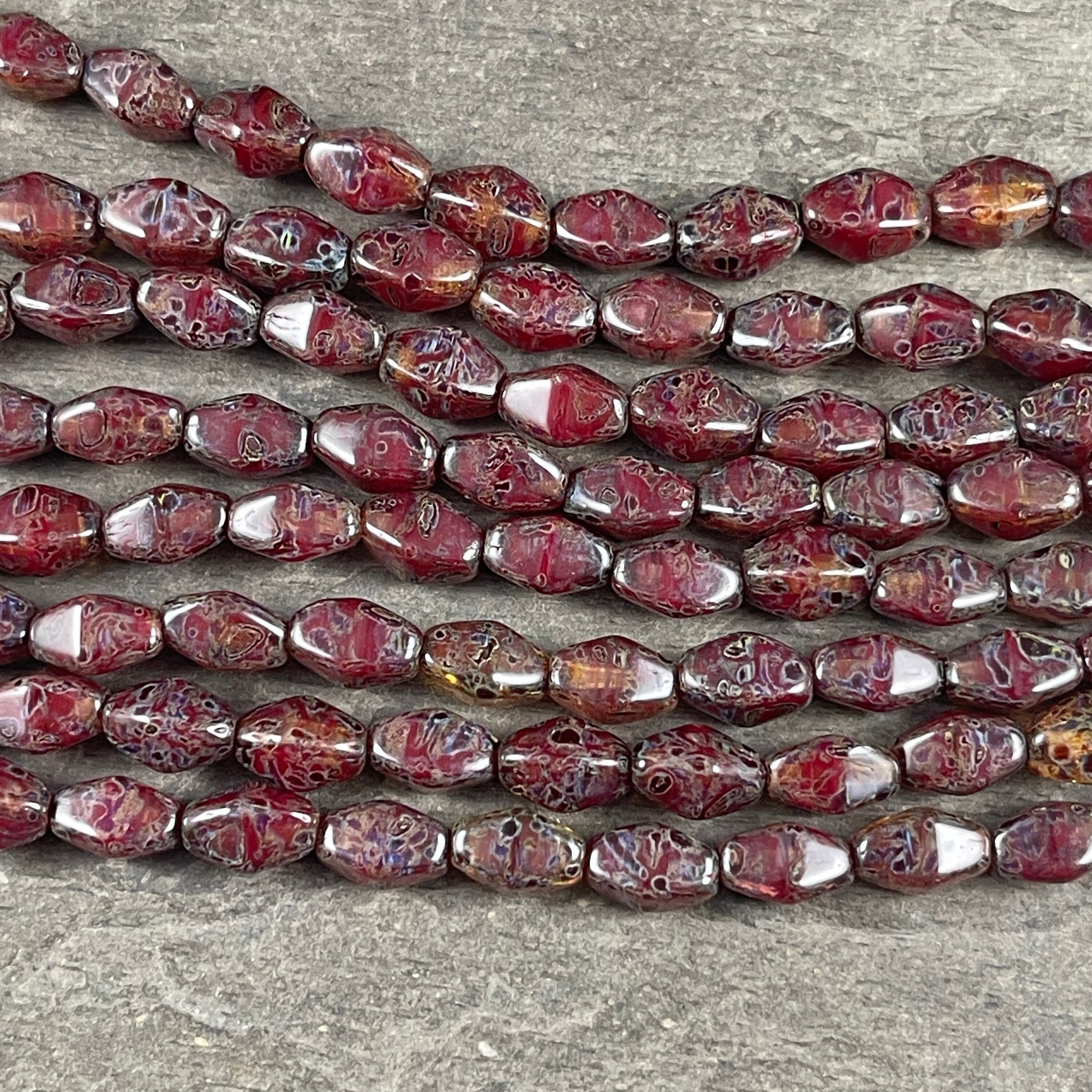 Transparent Crystal Red with Travertine Picasso , 8x6mm Dark Red, Rustic Picasso, Elongated Bicone (EB5) * Qty. 16