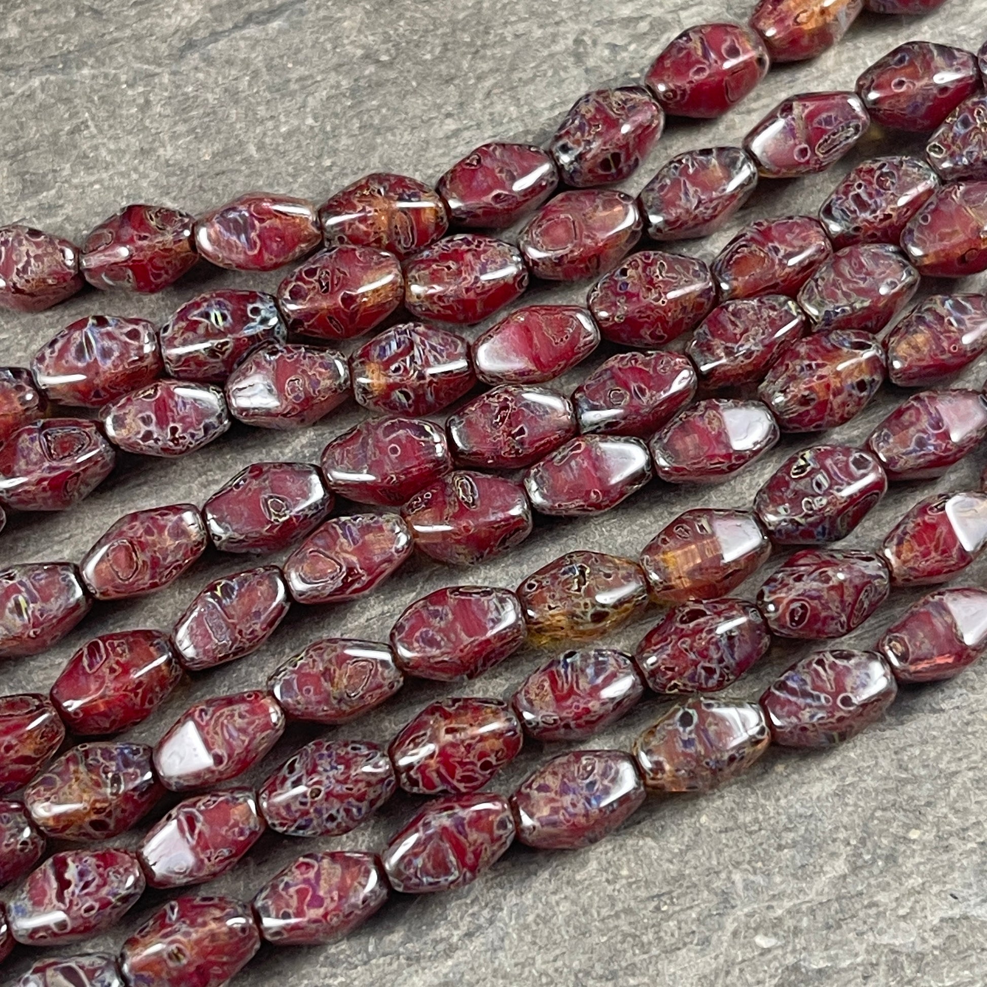 Transparent Crystal Red with Travertine Picasso , 8x6mm Dark Red, Rustic Picasso, Elongated Bicone (EB5) * Qty. 16