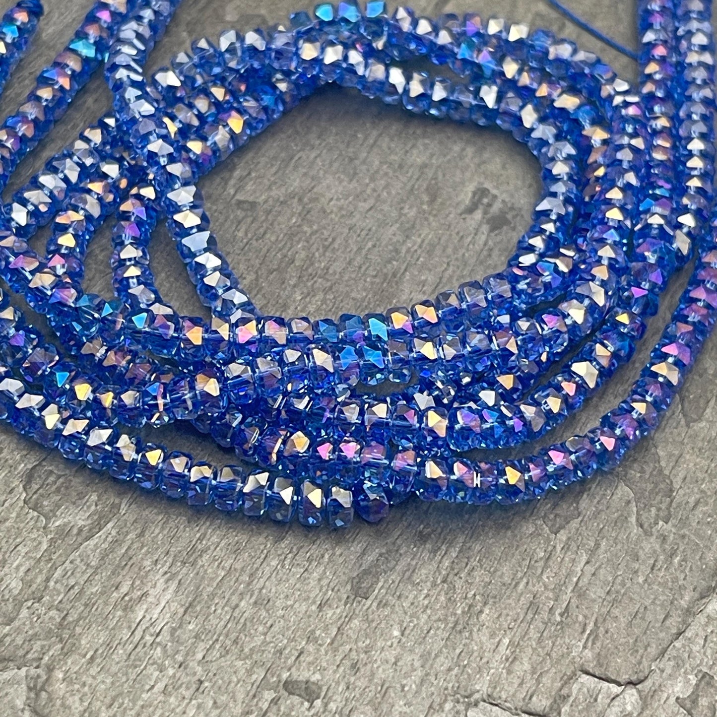 Faceted Glass Beads - 4x2.5mm Heishi Rondelles, Transparent Light Sapphire Blue with AB Finish (LtSapphire-AB) * 7" Strand