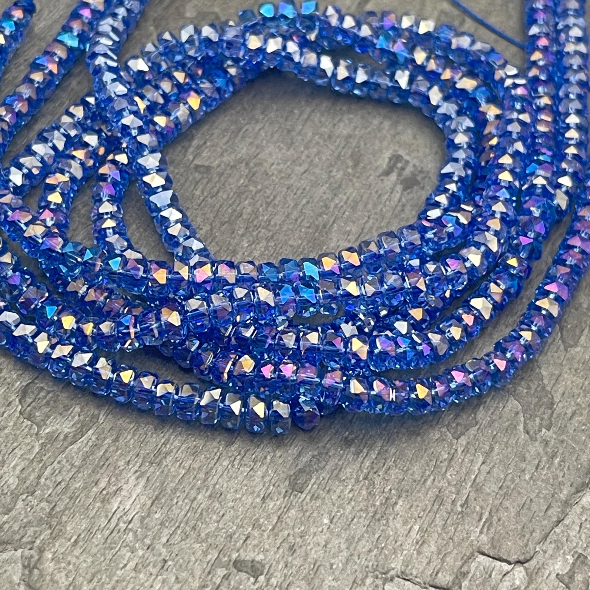 Faceted Glass Beads - 4x2.5mm Heishi Rondelles, Transparent Light Sapphire Blue with AB Finish (LtSapphire-AB) * 7" Strand