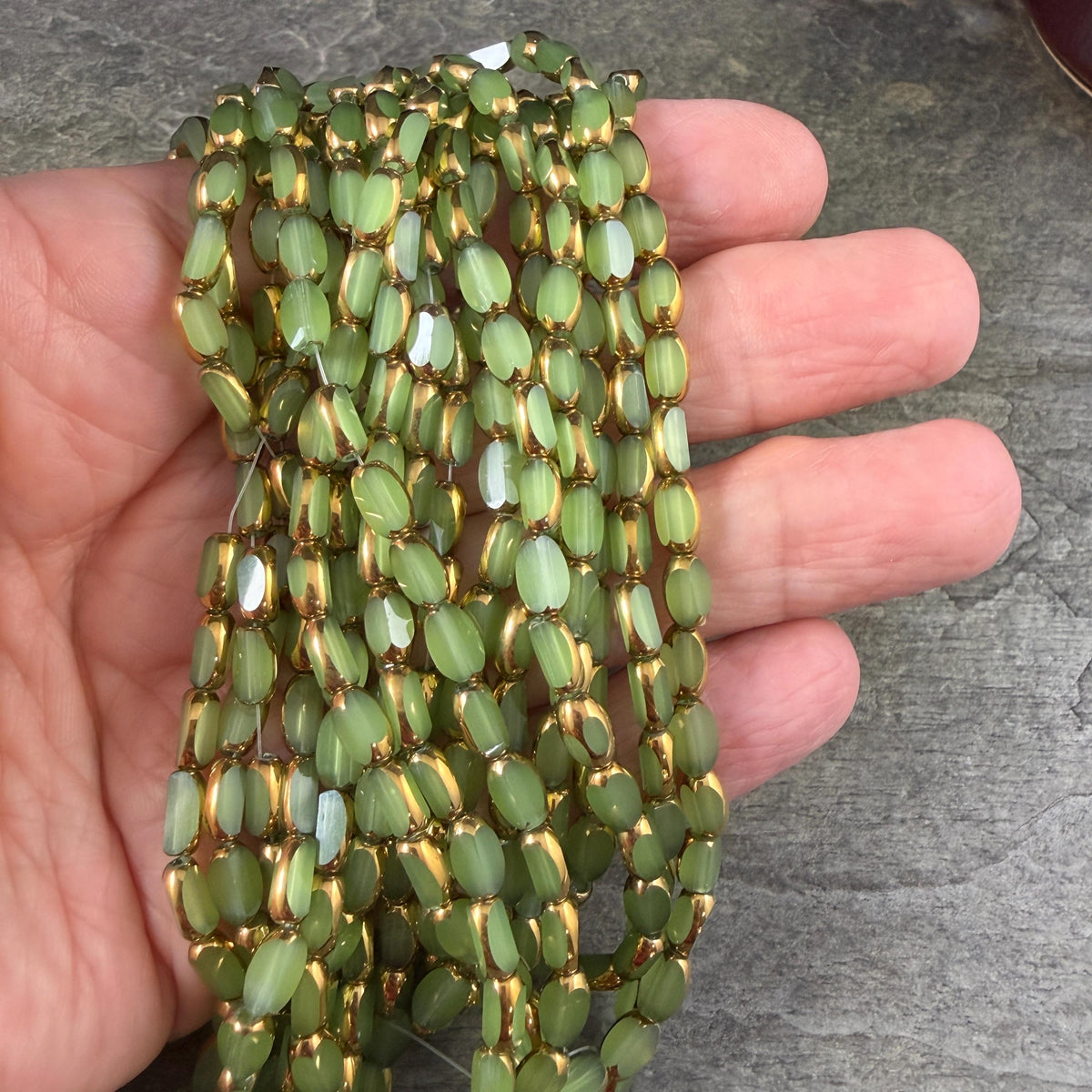 Electroplated Glass Beads - 7x4.5mm Faceted Oval, Milky Peridot Green with Gold Finish (A01-02A) * Qty. 50 Beads