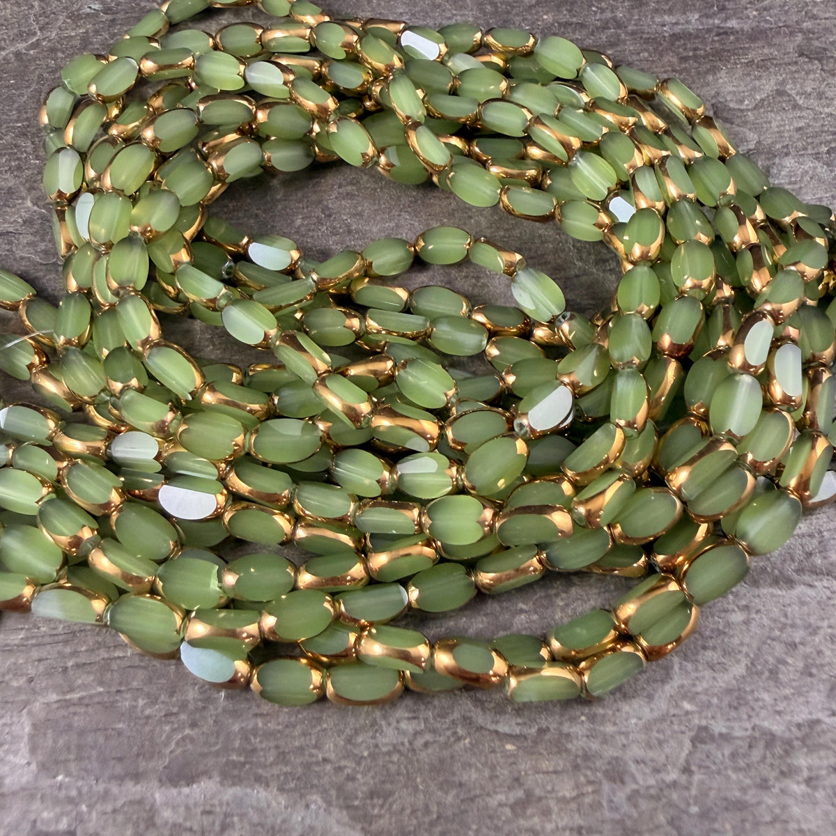 Electroplated Glass Beads - 7x4.5mm Faceted Oval, Milky Peridot Green with Gold Finish (A01-02A) * Qty. 50 Beads