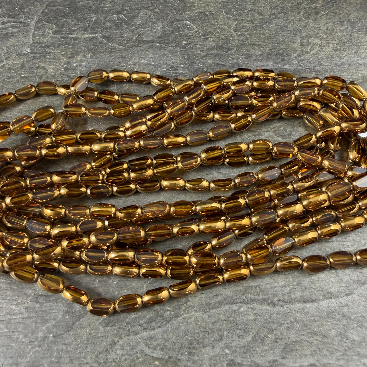 Electroplated Glass Beads - 7x4.5mm Faceted Oval, Transparent Brown with Gold Finish (A01-01E) * Qty. 50 Beads