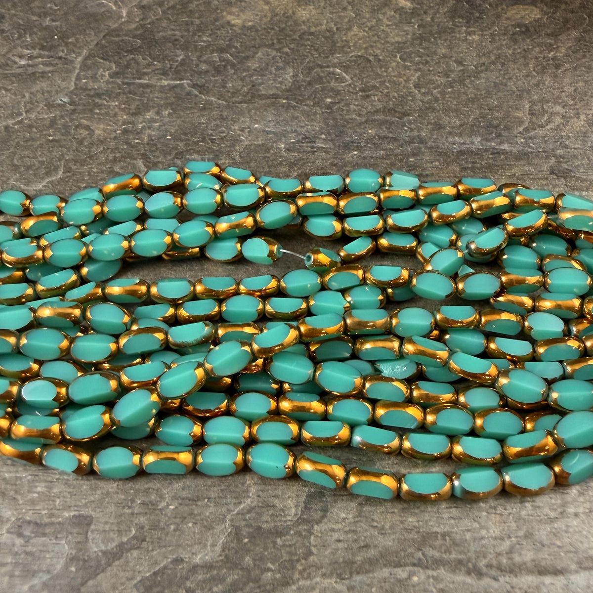 Electroplated Glass Beads - 7x4.5mm Faceted Oval, Opaque Dark Turquoise with Gold Finish (02A-04) * Qty. 50 Beads