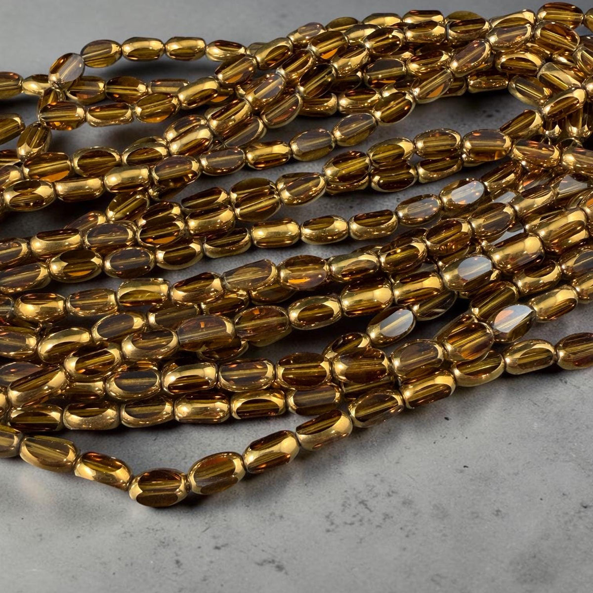 Electroplated Glass Beads - 7x4.5mm Faceted Oval, Transparent Brown with Gold Finish (A01-01E) * Qty. 50 Beads