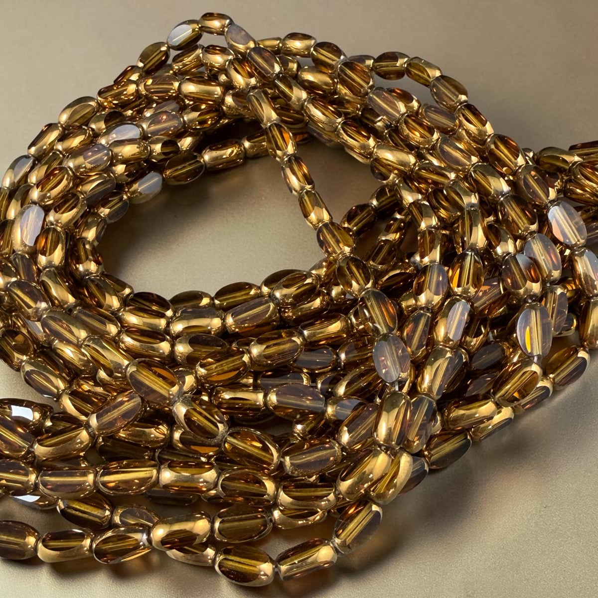Electroplated Glass Beads - 7x4.5mm Faceted Oval, Transparent Brown with Gold Finish (A01-01E) * Qty. 50 Beads