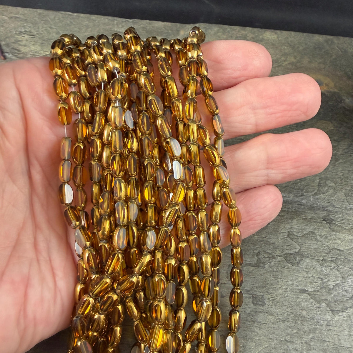 Electroplated Glass Beads - 7x4.5mm Faceted Oval, Transparent Brown with Gold Finish (A01-01E) * Qty. 50 Beads
