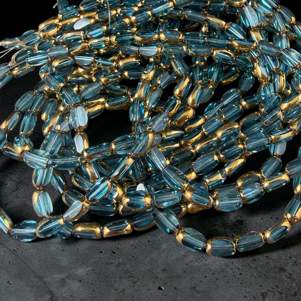 Electroplated Glass Beads - 7x4.5mm Faceted Oval, Transparent Lagoon Blue with Gold Finish (A01-01B) * Qty. 50 Beads