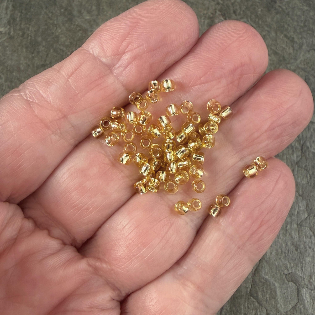 8/0 TOHO Glass Seed Beads, Rainbow Light Topaz, Black Lined (T8/SM-22) * 20 grams